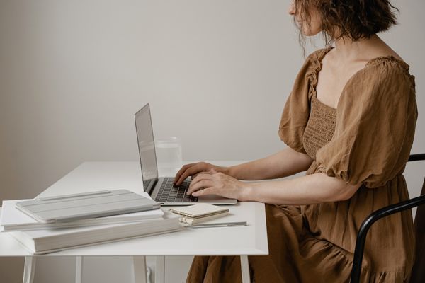 woman sitting at desk using laptop